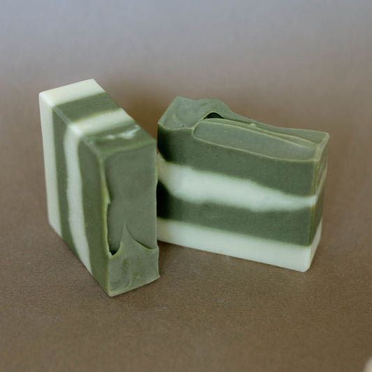 Two homemade bars of soap colored with organic spirulina powder and scented with a blend of essential oils