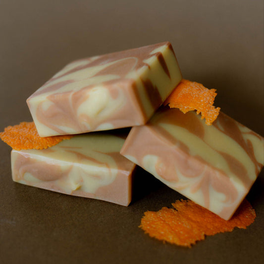 Three vegan bars made with orange clay and essential oils