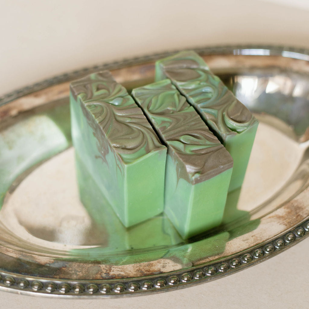 Green marbled soap bars on a silver tray