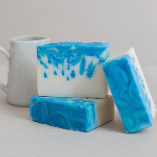 Three handmade bars of soap colored with tear drops of turquoise and marine blue. Scented with Shay and Company's beachwood vetiver fragrance oil