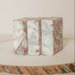 Marble-patterned handmade soaps on a textured wooden surface with a neutral background.