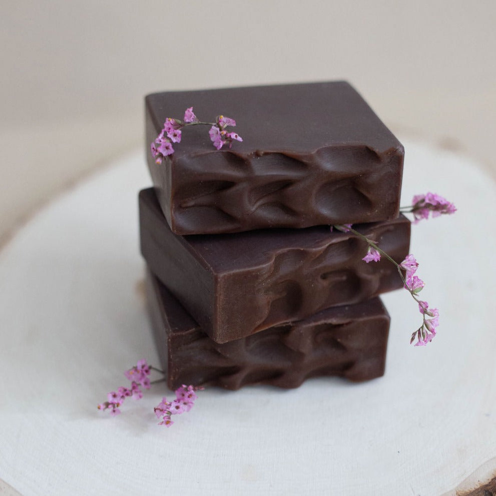 Three handmade bars of soap colored in deep, rich brown with textured rippled tops. Scented with Bramble Berry's Turkish mocha fragrance oil