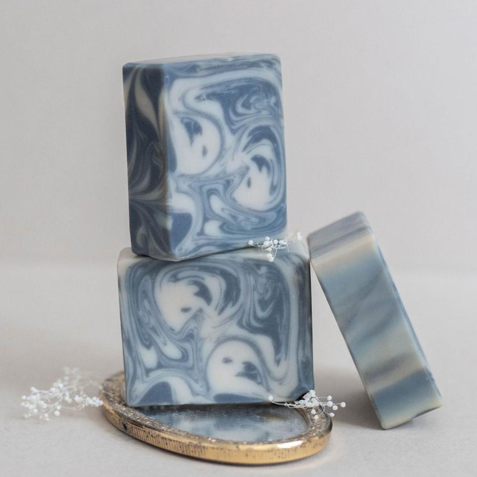 Three handmade bars of soap designed in intricate swirls of charcoal black and cream. Scented with Bramble Berry's Kentucky bourbon fragrance oil.