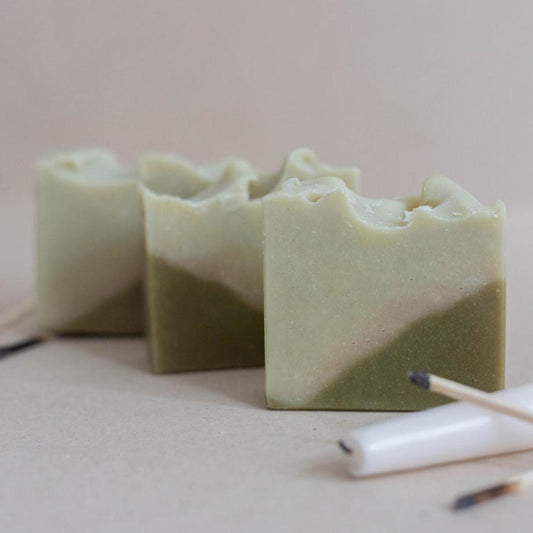 Three handmade, all-natural vegan bars of soap scented with a blend of lemon, lemongrass and rosemary essential oil. Designed with a green triangle base and soft green top.